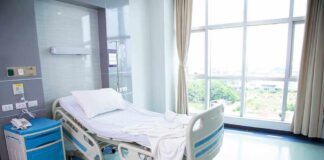 Empty hospital room with a single bed.