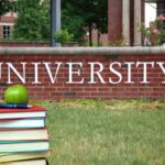 Michael Roth Challenges Political Critiques Targeting University Systems Books and apple in front of university sign
