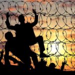 Trump’s Gold Card: A New Challenge for the EB-5 Visa Program? Silhouette of people helping each other over fence