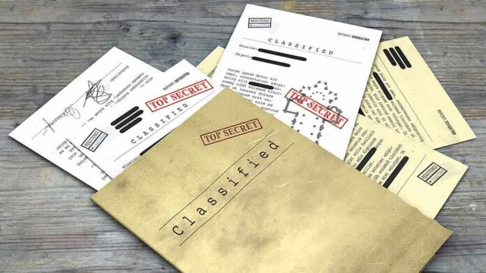 1099529729 featured image Classified documents with "Top Secret" stamps on wooden surface.