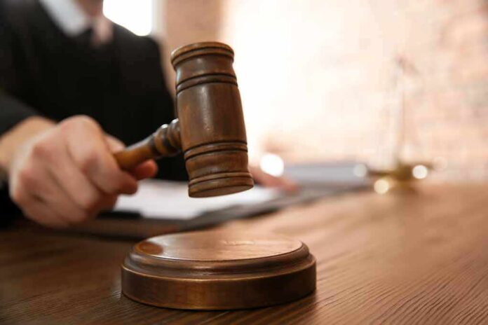 1342761677 featured image Judge with gavel on wooden desk courtroom setting
