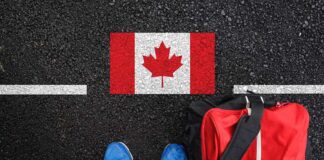 Shoes and bag beside painted Canadian flag.