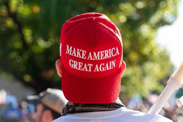 1850438311 featured image Red "Make America Great Again" hat on person's head.