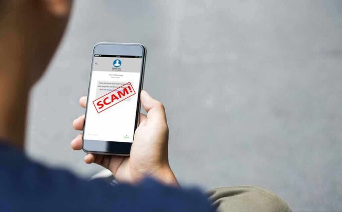 2058303887 featured image Person reading a scam message on a smartphone.