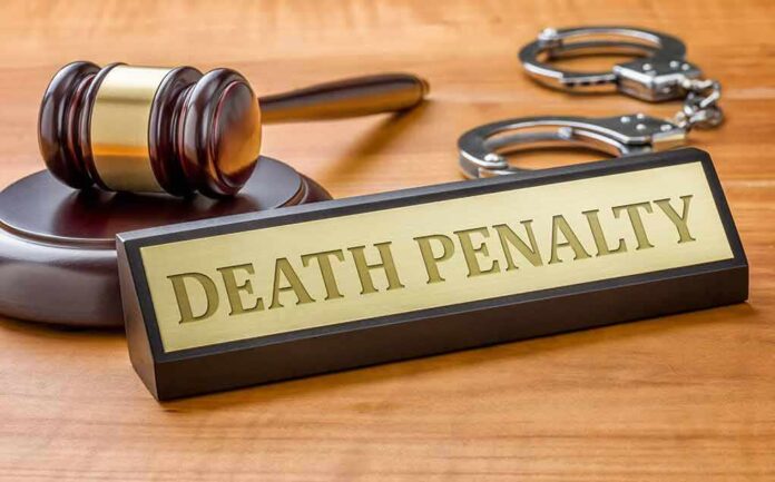 346370309 featured image Gavel, handcuffs, and "Death Penalty" sign on desk.