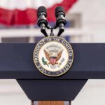 Vice Presidential podium with microphones and emblem.