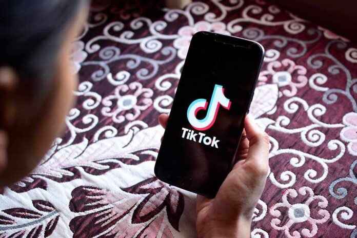 1378101017 featured image Hand holding phone showing TikTok logo.