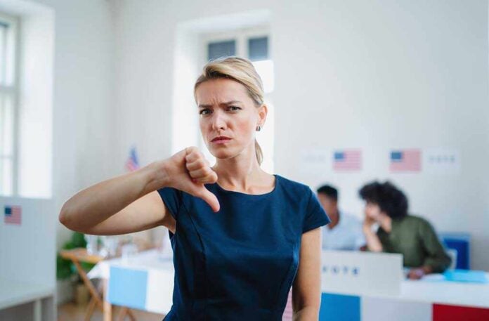 1823718170 featured image Woman with thumbs down in voting location.