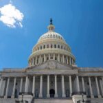 Senate Race Controversy: Uniform Misuse Sparks Ethics Debate for Ken Paxton U.S. Capitol building against a clear blue sky.