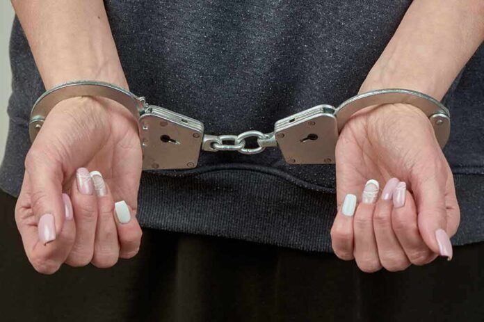 2295282433 featured image Hands with manicured nails in handcuffs.