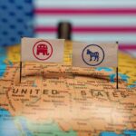 Senator Fetterman Stands Against Proposed Changes to Key Social Programs Republican and Democratic flags on USA map background.