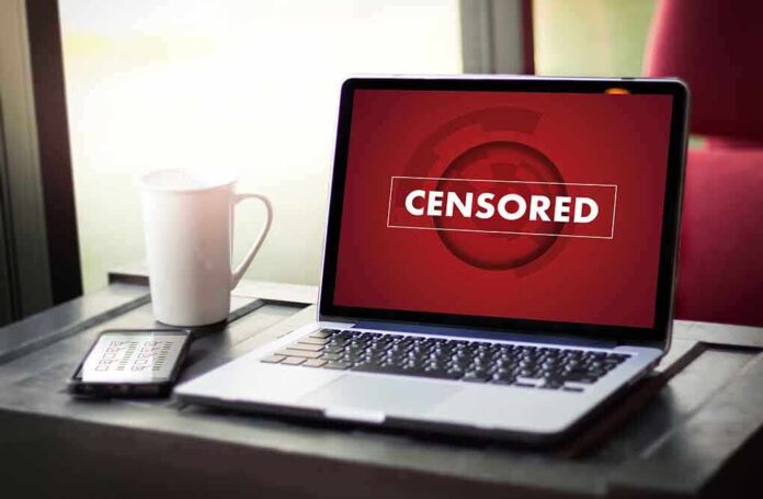 613288766 featured image Laptop screen displaying CENSORED beside coffee and phone