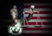 Blindfolded Lady Justice in front of American flag