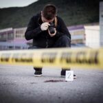 Unraveling the Enigma of a Corpse Discovered by Utah Railroad Tracks Photographer documenting crime scene behind caution tape
