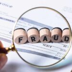 Magnifying glass showing fraud on an invoice.