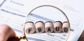 Magnifying glass showing fraud on an invoice.
