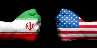 Two fists painted with Iran and USA flags