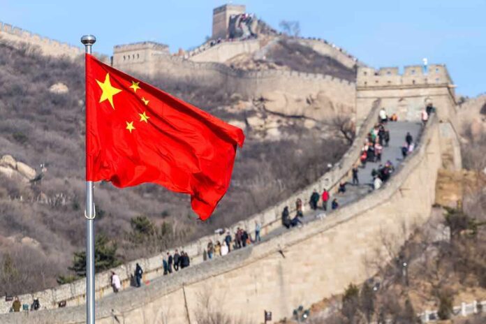 1145455832 featured image Chinese flag by the Great Wall of China.