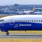 Boeing on airport runway with other planes