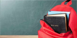 Red backpack with a Bible and books inside