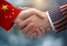 Chinese and American flag sleeves shaking hands