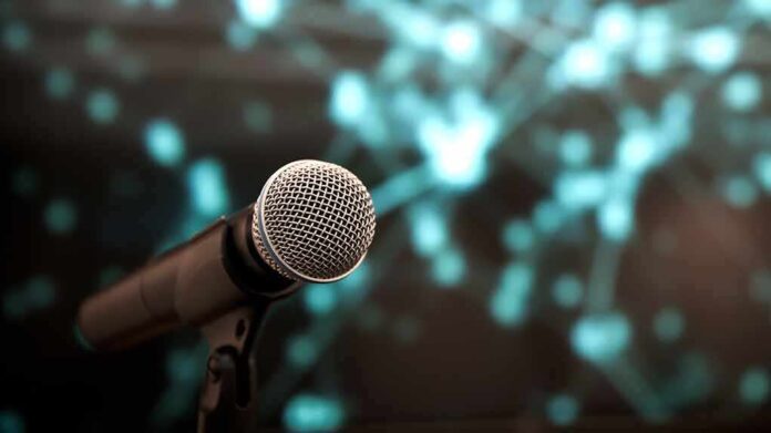 1934847146 featured image Microphone with abstract blurred blue background