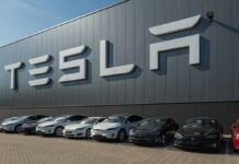Tesla facility with parked cars in front