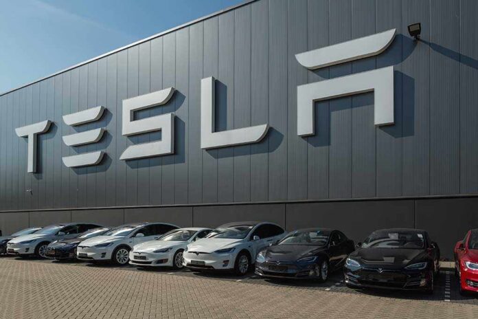 Tesla facility with parked cars in front