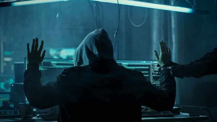680075263 featured image Hacker in hoodie arrested at computer desk