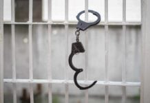 Handcuffs hanging on a barred window