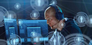 Man with headset working at computer, holographic icons