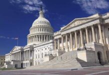 The US Capitol building with its dome and columns under a blue sky