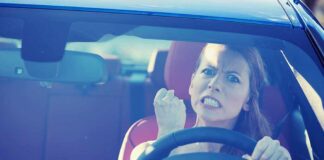 Angry woman gripping the steering wheel in a car