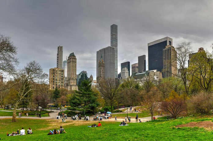 City skyline with park and people relaxing.