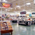 Metabolic Mayhem: Is Your Body Sabotaging Your Brain? Supermarket interior with various food sections and displays