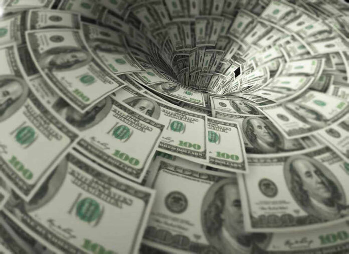 Hundred-dollar bills swirling into a financial vortex.