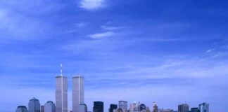 Skyline of New York City featuring the Twin Towers against a blue sky