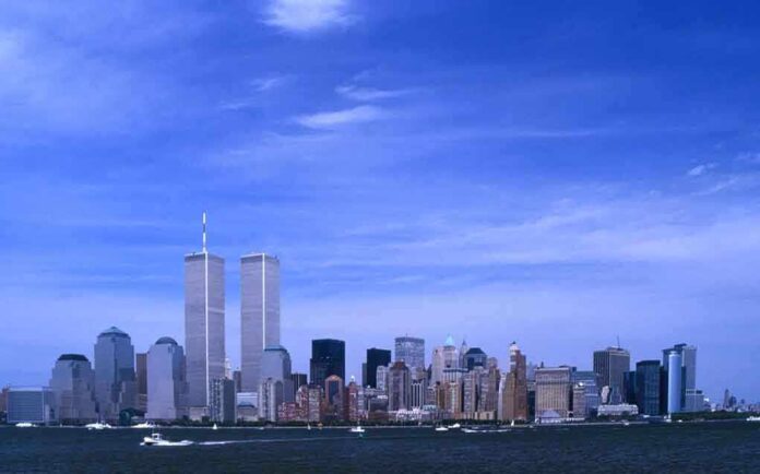 Skyline of New York City featuring the Twin Towers against a blue sky