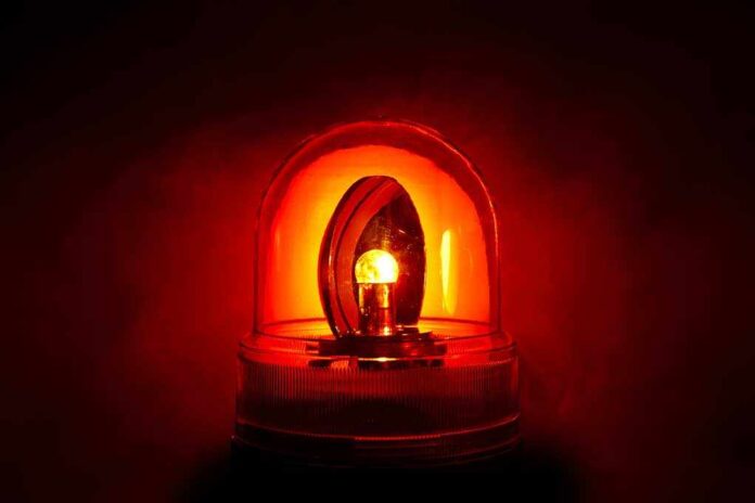 Red emergency light illuminated against a dark background