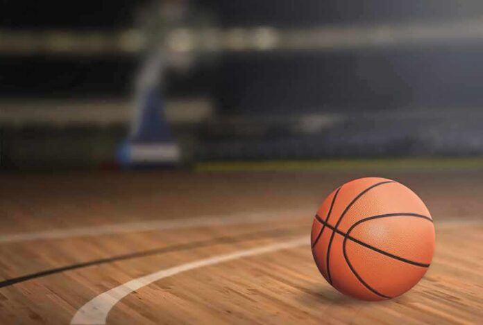shutterstock_377181817.jpg A basketball resting on a wooden court