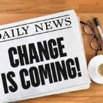 Newspaper headline Change Is Coming on table