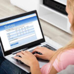 Person filling survey on a laptop.