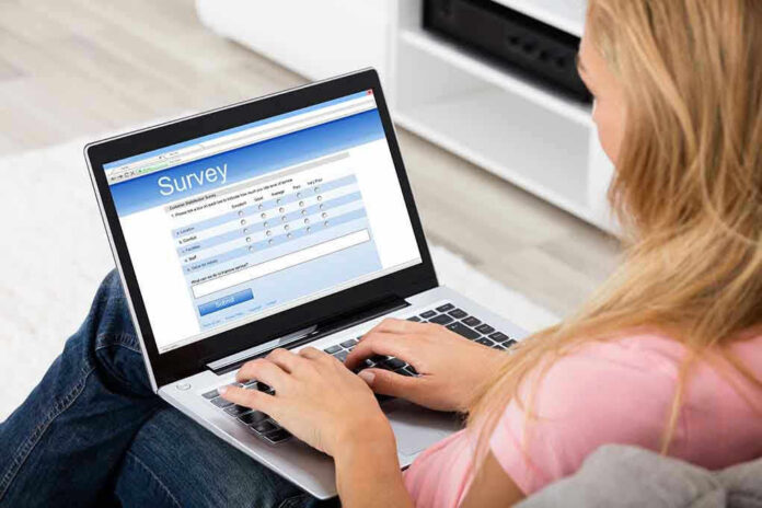 Person filling survey on a laptop.