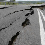 FOUR-KILOMETER Crack Splits Town Road damaged by significant cracks and fissures.