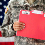 U.S. Army soldier holds a Top Secret folder.