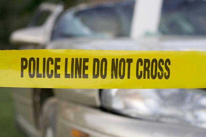 Yellow police tape in front of a car.