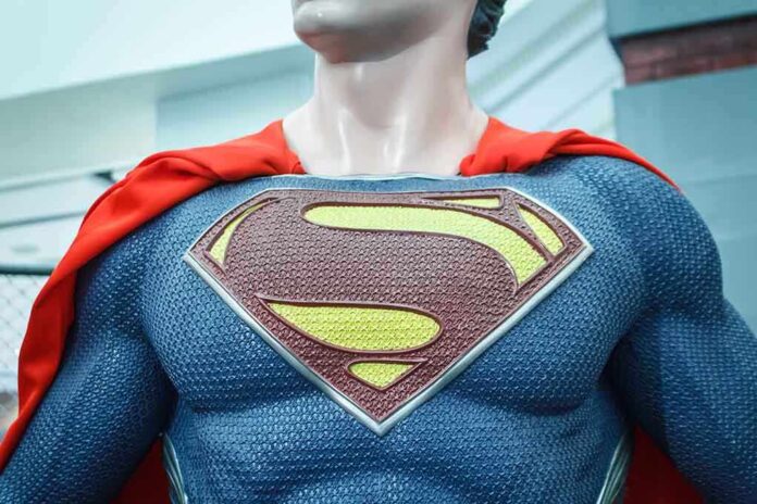 Close-up of a Superman statue wearing a blue costume and red cape