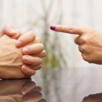 Warren-Trump Unexpected AGREEMENT Shocks DC Two hands in a tense conversation, one hand pointing and the other clasped together