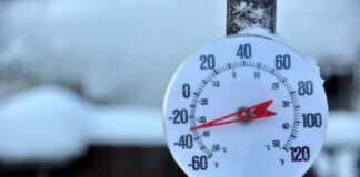 Outdoor thermometer displaying a very low temperature in a snowy setting