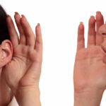 Person whispering into another persons ear gesture